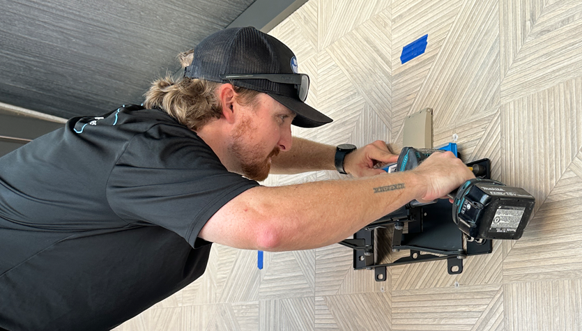 Who's Your Tech technician installing a tv mount